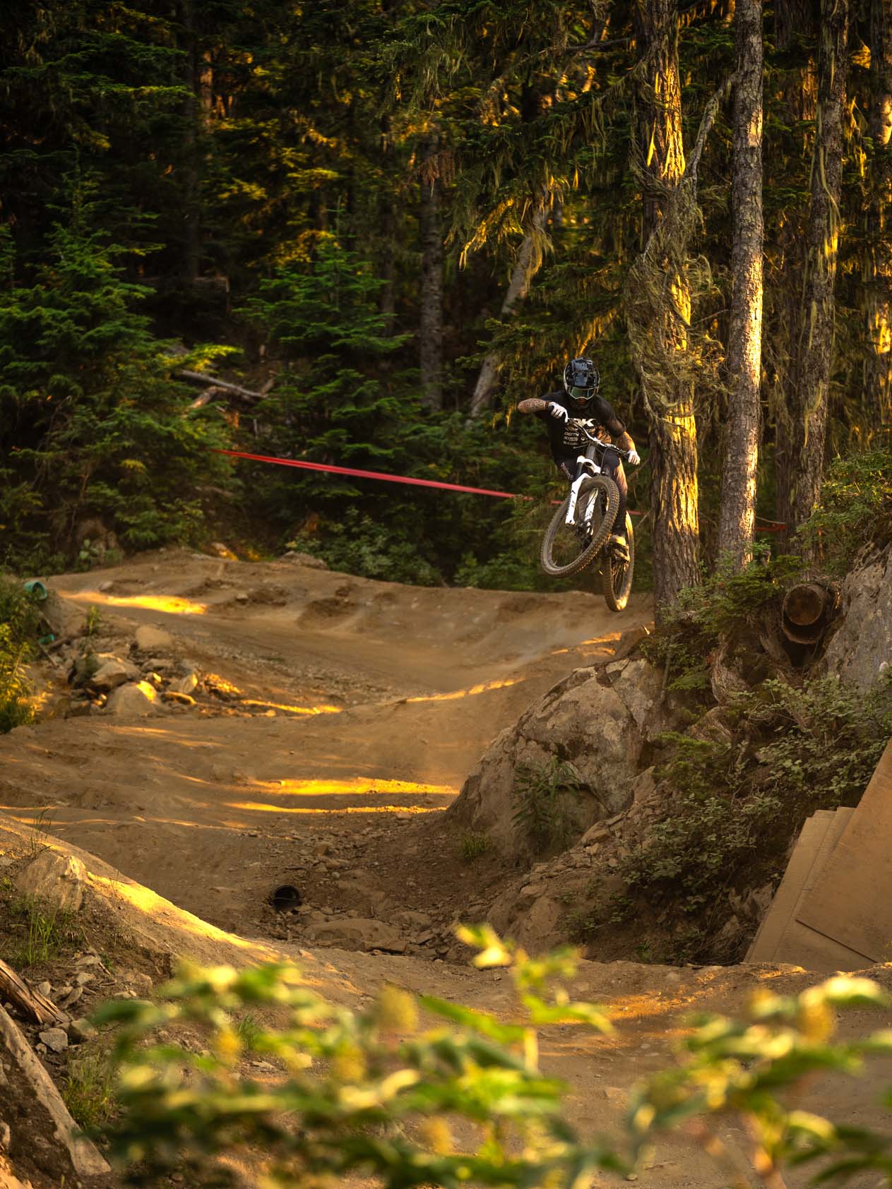 Rider gapping a berm in late evening light